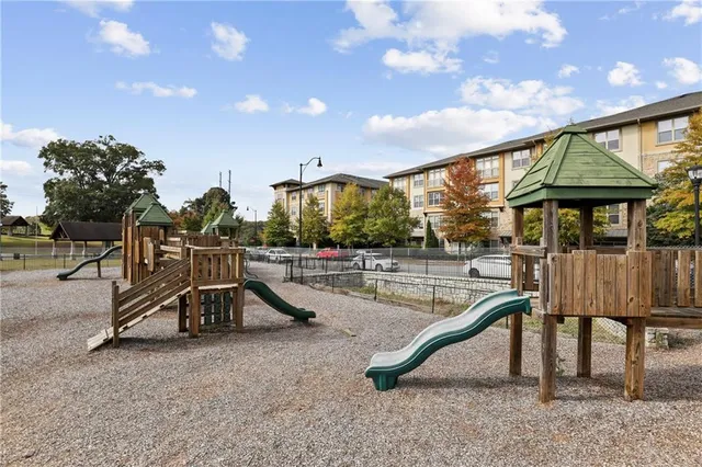 a view of a swimming pool with a patio and a garden