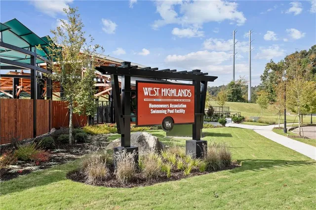 a view of a street with a building and trees in the background