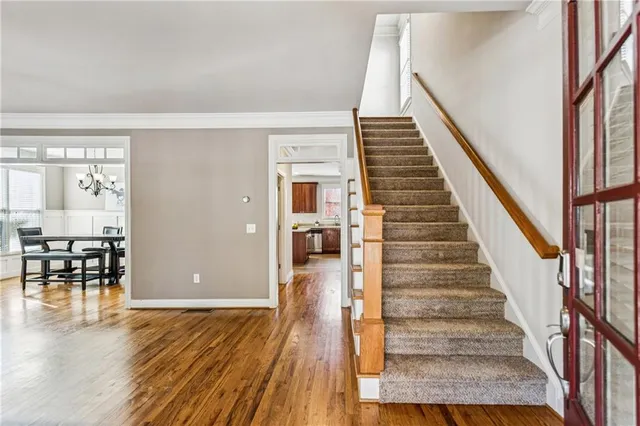 a view of entryway and hall with wooden floor