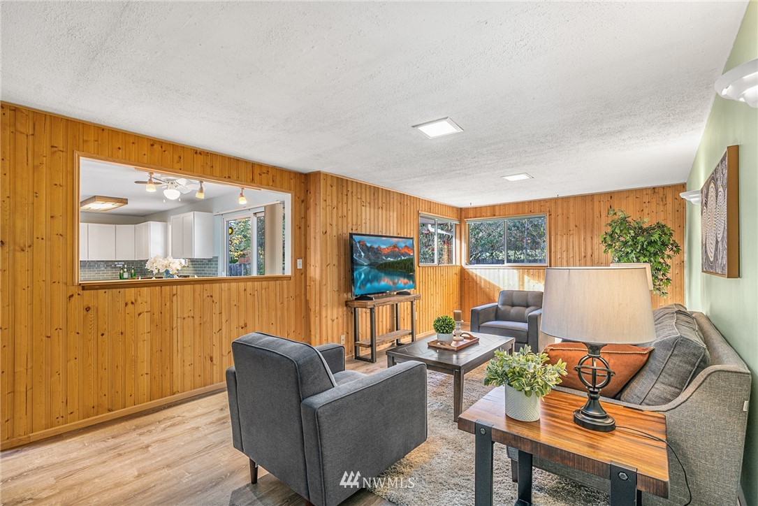 105 232nd Place Southwest Bothell, WA 98021 - Photo 18 of 39 a living room with furniture wooden floor and a large window