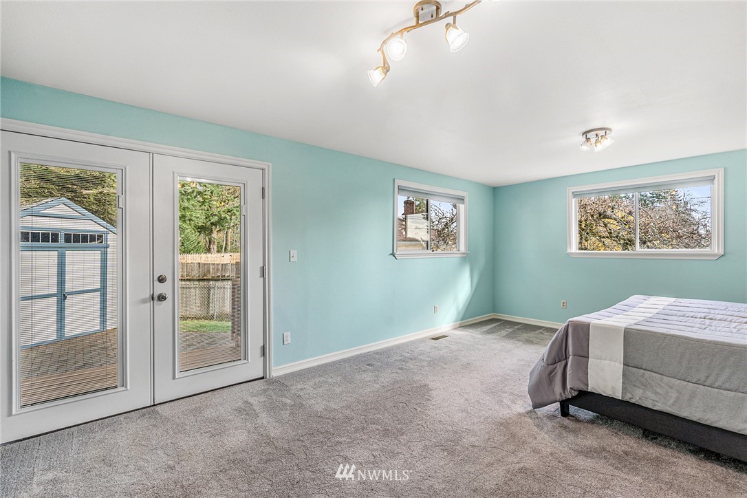 105 232nd Place Southwest Bothell, WA 98021 - Photo 19 of 39 a bedroom with a bed and a painting on the wall
