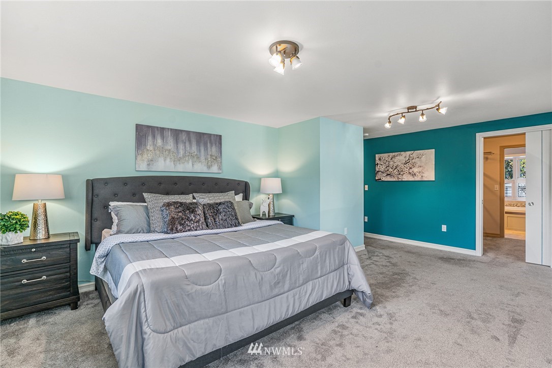 105 232nd Place Southwest Bothell, WA 98021 - Photo 20 of 39 a bedroom with a bed and a painting on the wall