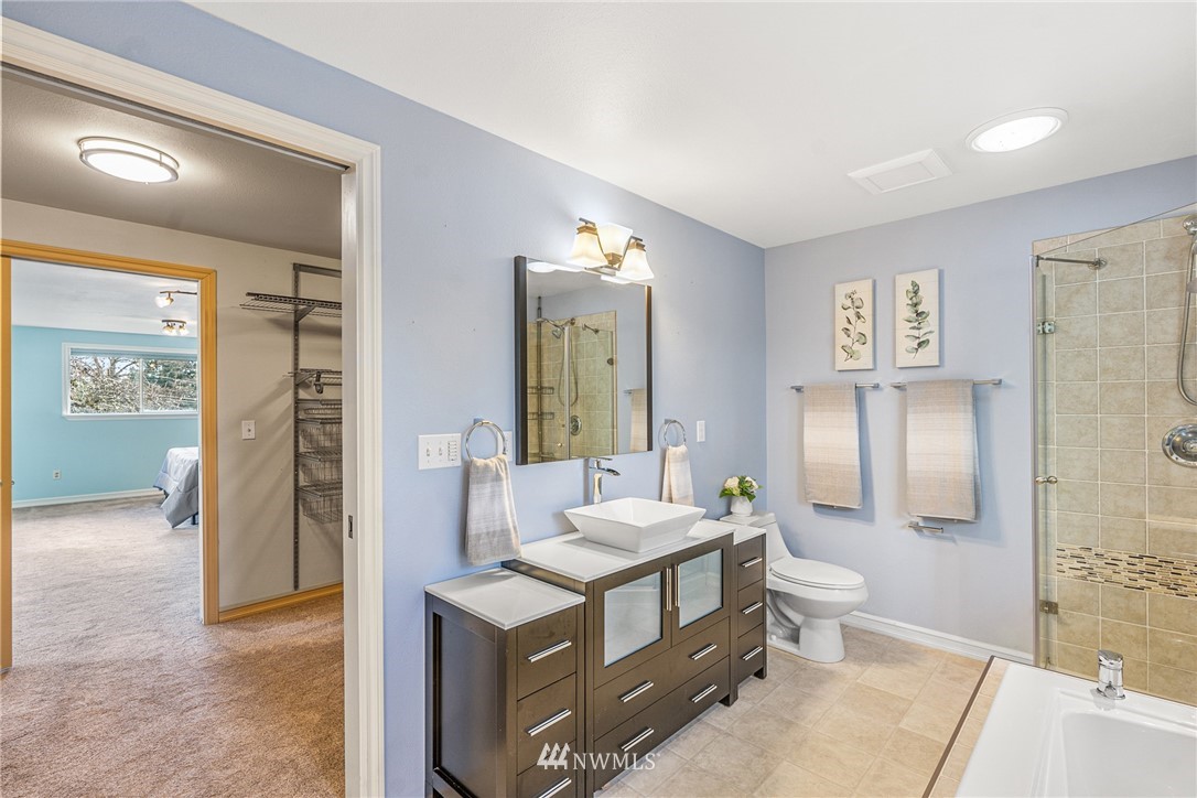 105 232nd Place Southwest Bothell, WA 98021 - Photo 21 of 39 a spacious bathroom with a double vanity sink toilet and shower