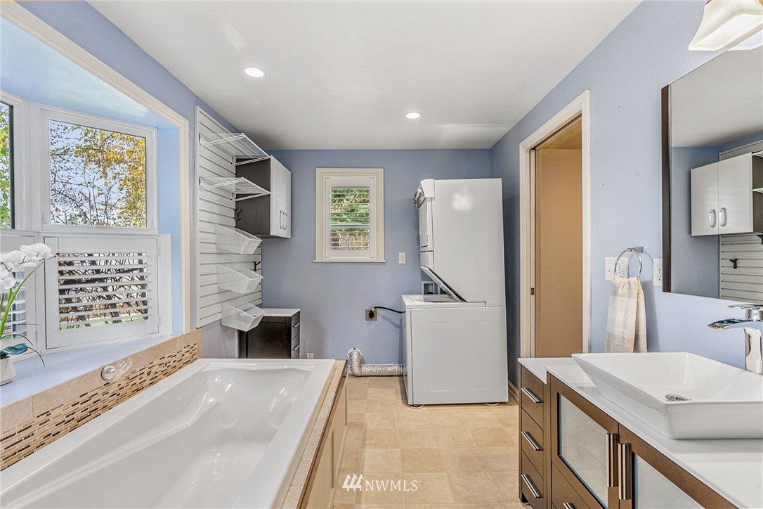 105 232nd Place Southwest Bothell, WA 98021 - Photo 24 of 39 a spacious bathroom with a tub sink and mirror