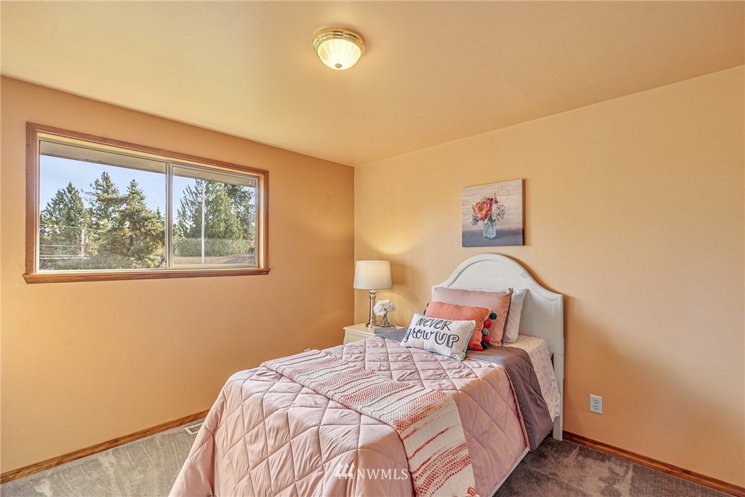 105 232nd Place Southwest Bothell, WA 98021 - Photo 27 of 39 a bedroom with a bed and a painting on the wall