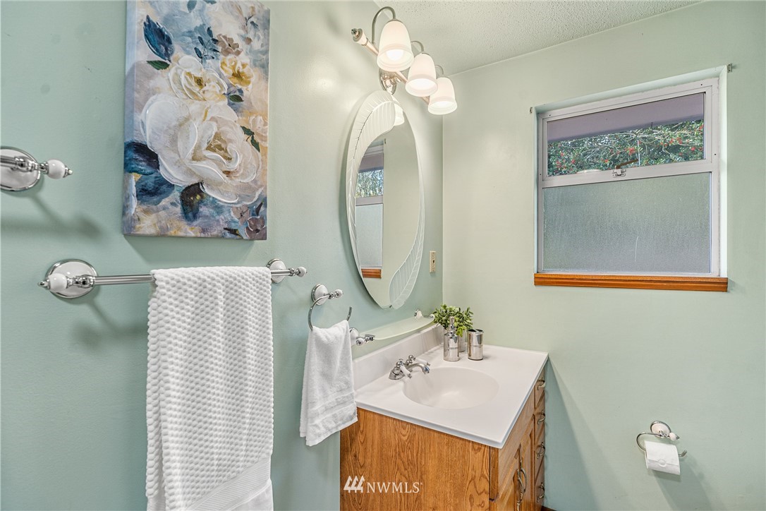 105 232nd Place Southwest Bothell, WA 98021 - Photo 28 of 39 a bathroom with a sink mirror and vanity