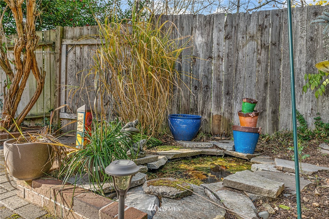 105 232nd Place Southwest Bothell, WA 98021 - Photo 32 of 39 a view of a backyard with plants and chairs