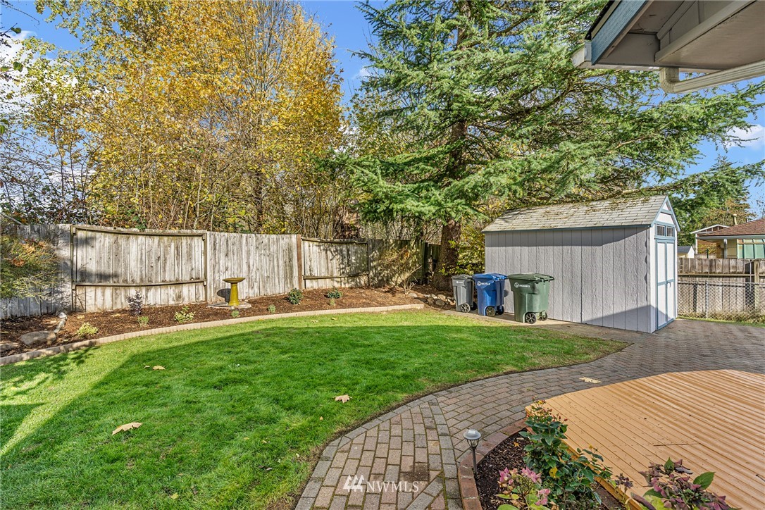 105 232nd Place Southwest Bothell, WA 98021 - Photo 34 of 39 a backyard of a house with table and chairs and a large tree