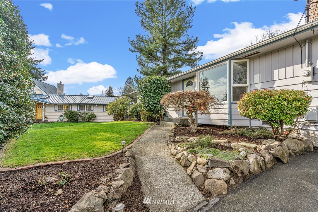 105 232nd Place Southwest Bothell, WA 98021 - Photo 5 of 39 a house view with a seating space and garden