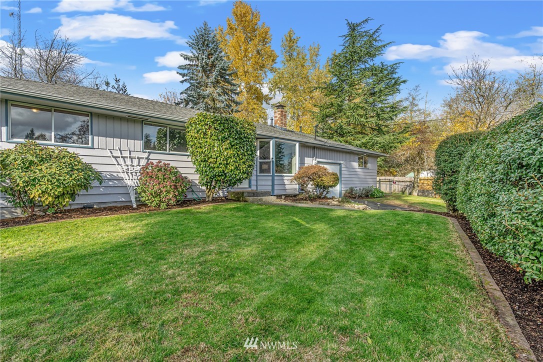 105 232nd Place Southwest Bothell, WA 98021 - Photo 6 of 39 a view of a house with backyard sitting area and garden