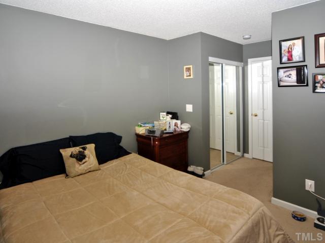 5805 Ricker Road Raleigh, NC 27610 - Photo 7 of 12 a bedroom with a bed and window