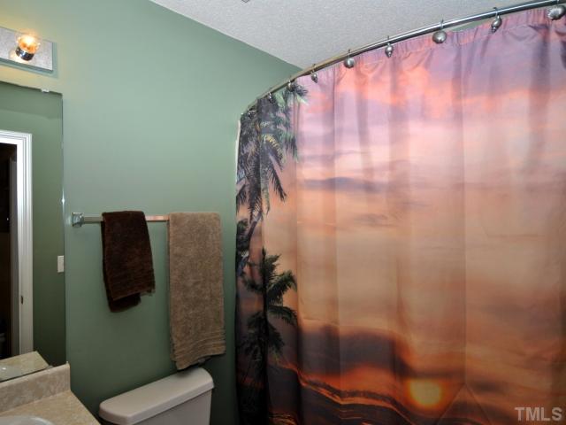 5805 Ricker Road Raleigh, NC 27610 - Photo 8 of 12 a bathroom with a shower and toilet