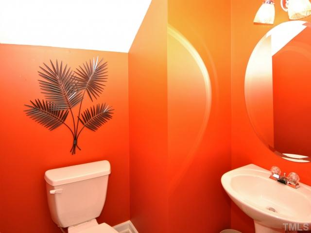 5805 Ricker Road Raleigh, NC 27610 - Photo 10 of 12 a bathroom with a toilet sink and mirror