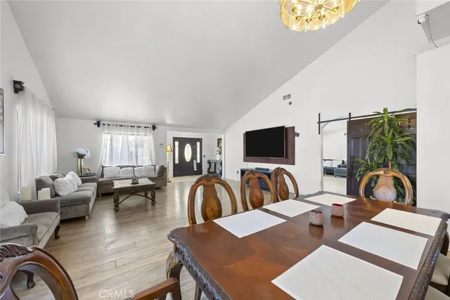 a living room with furniture a rug and a flat screen tv
