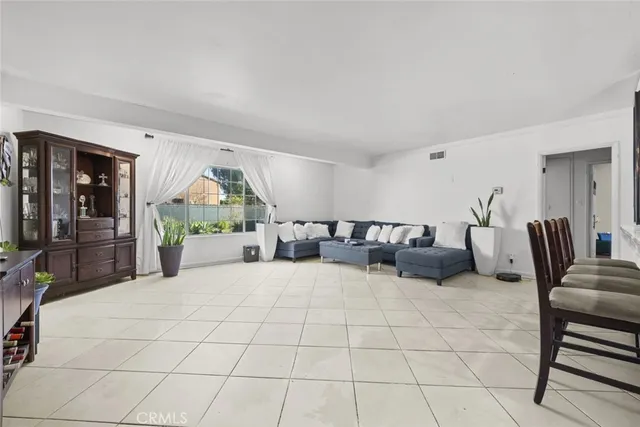 a large bedroom with a bed a couch and dresser