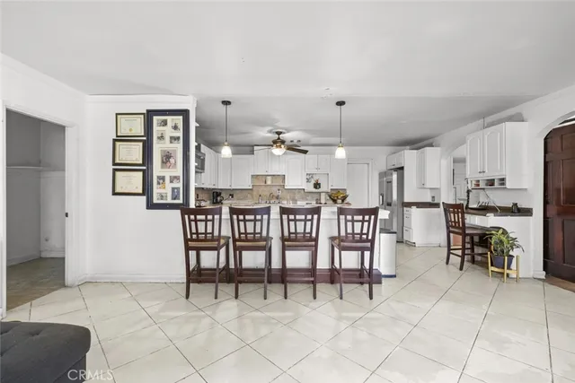 a dining room filled with furniture and view kitchen