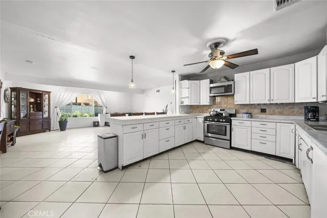 a kitchen with a stove cabinets and window