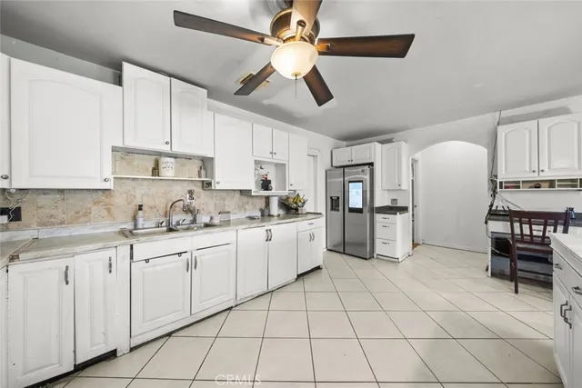 a kitchen with white cabinets and white appliances