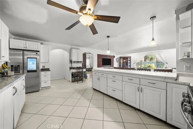 a large white kitchen with cabinets