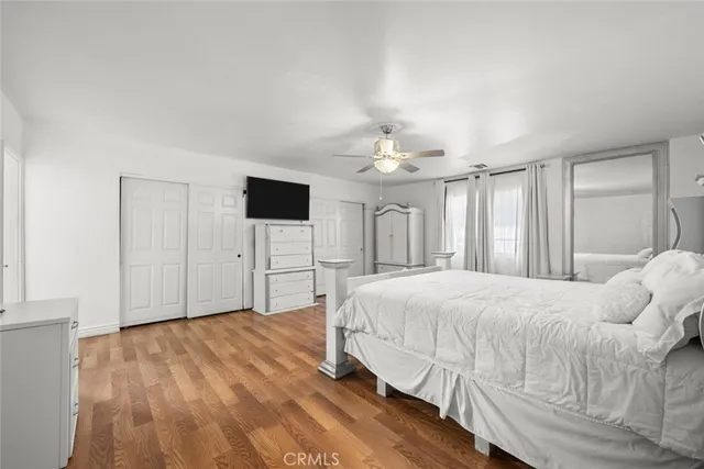 a spacious bedroom with a bed and a chandelier