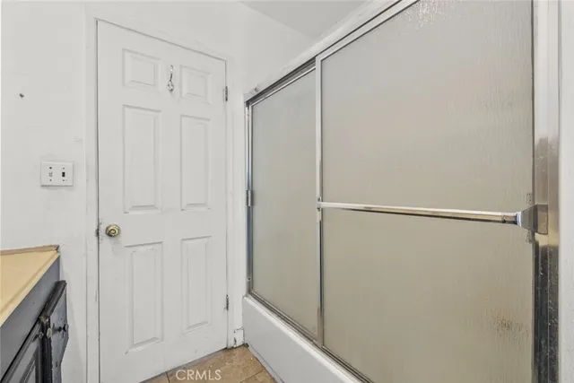 a bathroom with a glass shower door