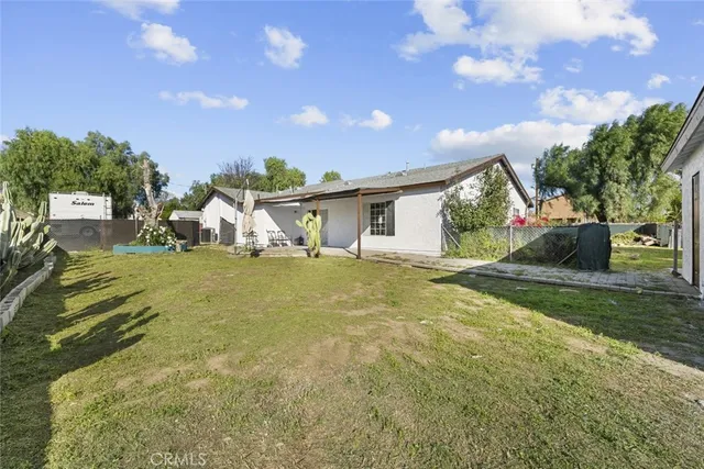 a yellow house with trees in front of it
