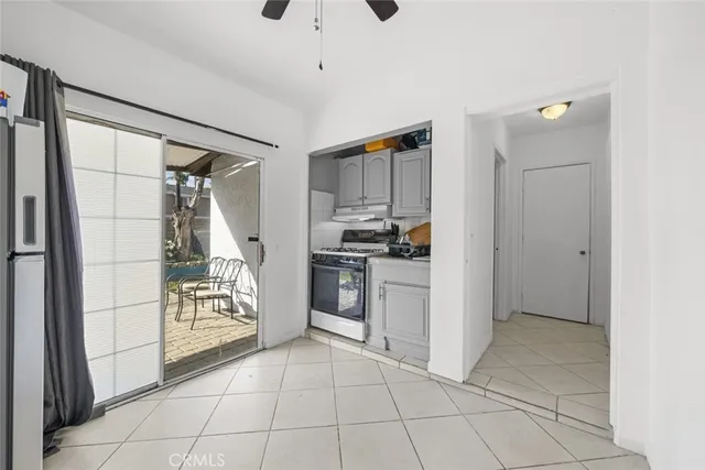 a kitchen with white cabinets and appliances