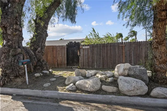 a backyard of a house with table and chairs