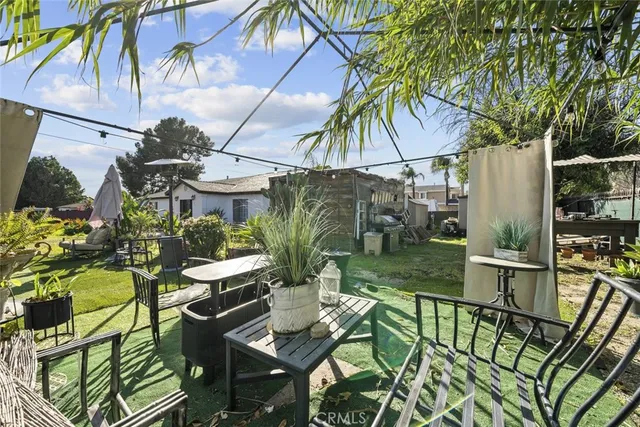 an aerial view of a house with a yard and large trees