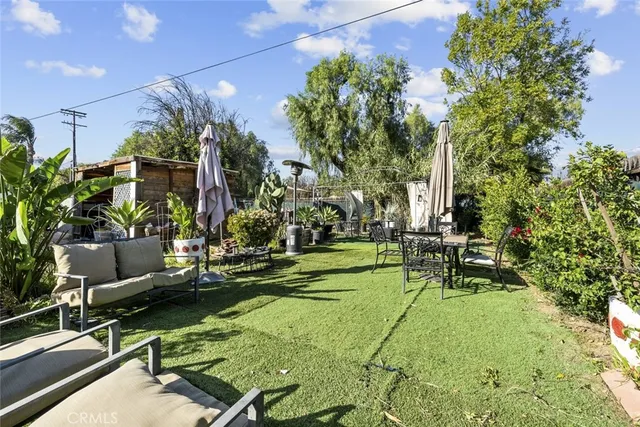 an aerial view of a residential apartment building with a yard and plants