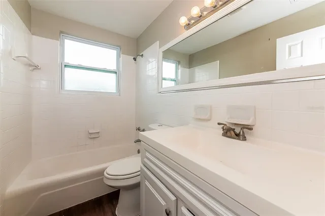 a bathroom with a sink a toilet and a bathtub