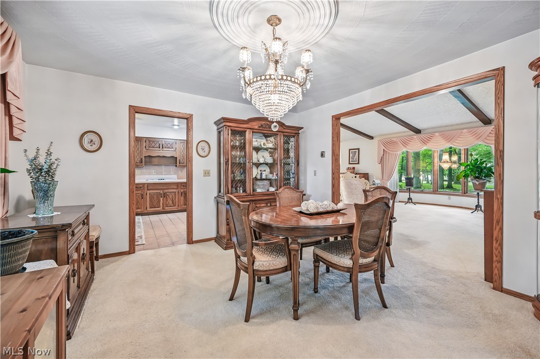 2717 Niles Vienna Road Niles, OH 44446 - Photo 10 of 50 Dining area with light colored carpet and a chandelier