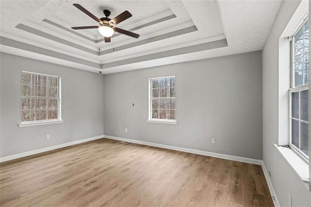 253 Ruth Drive Newnan, GA 30265 - Photo 12 of 25 wooden floor in an empty room with a window