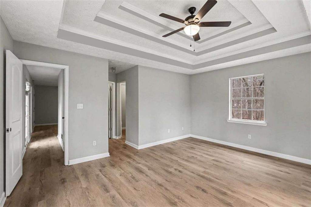 253 Ruth Drive Newnan, GA 30265 - Photo 13 of 25 wooden floor in an empty room with a window