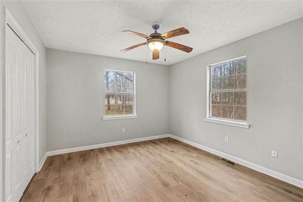 253 Ruth Drive Newnan, GA 30265 - Photo 18 of 25 a view of an empty room with wooden floor and a window