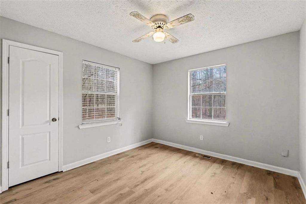 253 Ruth Drive Newnan, GA 30265 - Photo 20 of 25 an empty room with wooden floor and windows