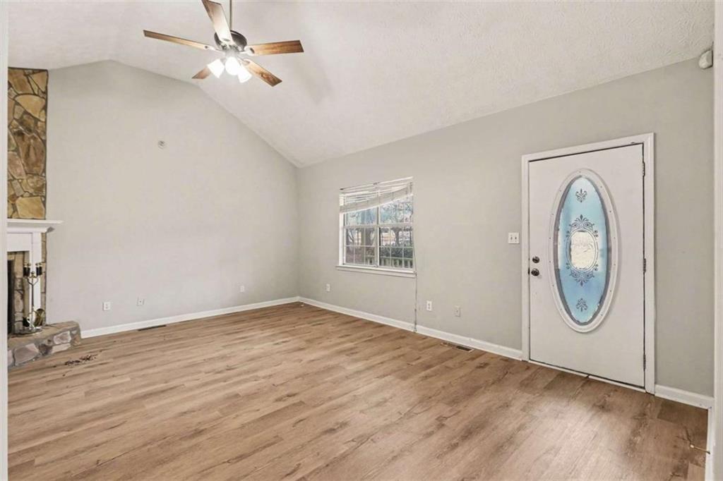 253 Ruth Drive Newnan, GA 30265 - Photo 2 of 25 a view of a livingroom with wooden floor and a ceiling fan