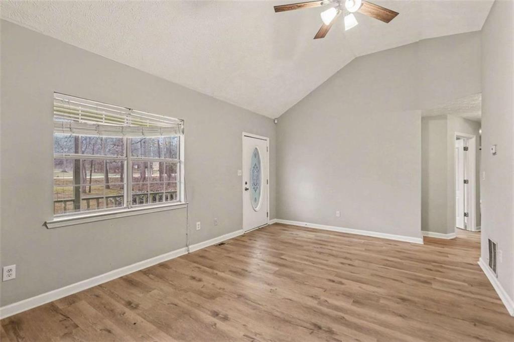 253 Ruth Drive Newnan, GA 30265 - Photo 3 of 25 a view of an empty room with wooden floor and a window