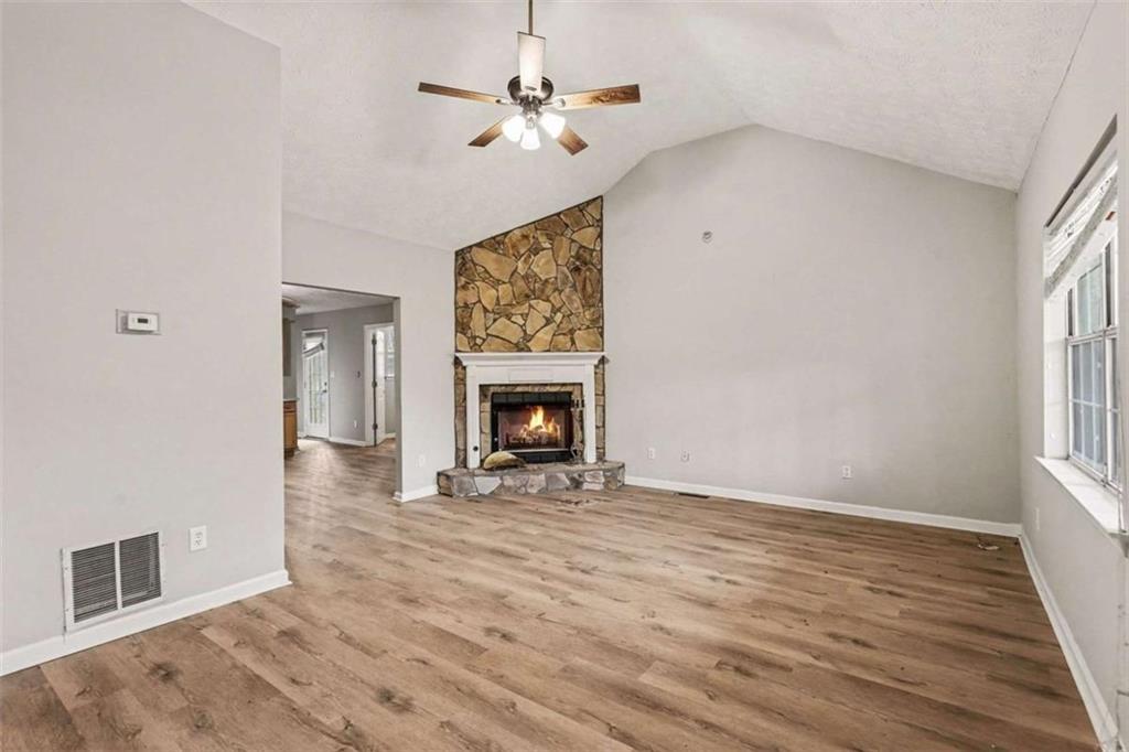 253 Ruth Drive Newnan, GA 30265 - Photo 4 of 25 wooden floor fireplace and windows in an empty room