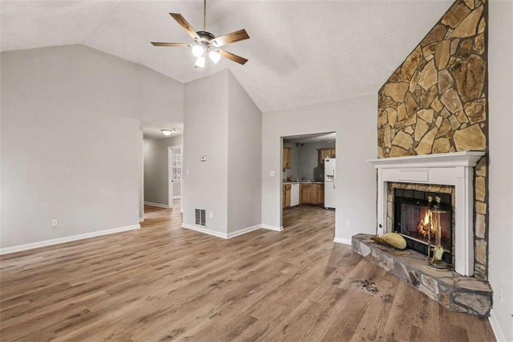 253 Ruth Drive Newnan, GA 30265 - Photo 5 of 25 a view of a livingroom with a fireplace and ceiling fan
