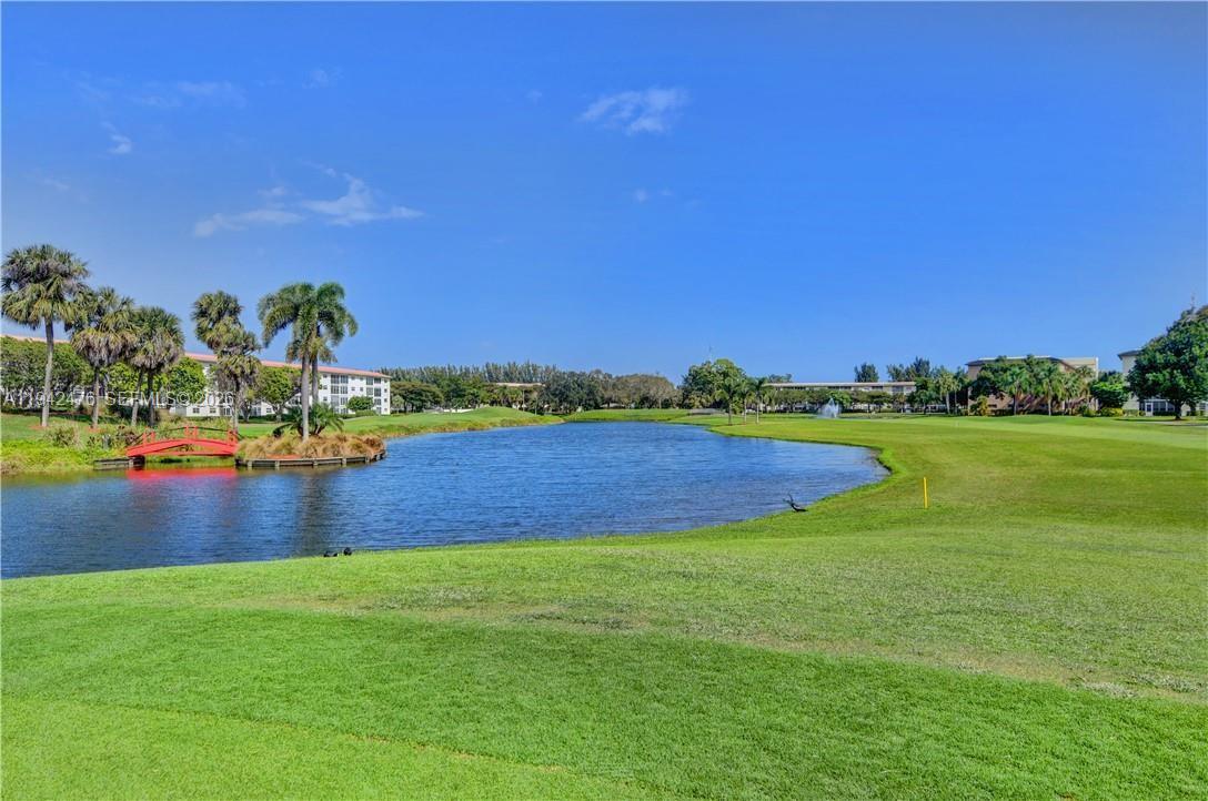 1902 Bermuda Circle, Unit E2 Coconut Creek, FL 33066 - Photo 23 of 30 a view of a golf course with a lake view
