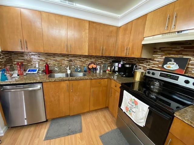 1902 Bermuda Circle, Unit E2 Coconut Creek, FL 33066 - Photo 4 of 30 a kitchen with stainless steel appliances granite countertop a stove a sink and a microwave