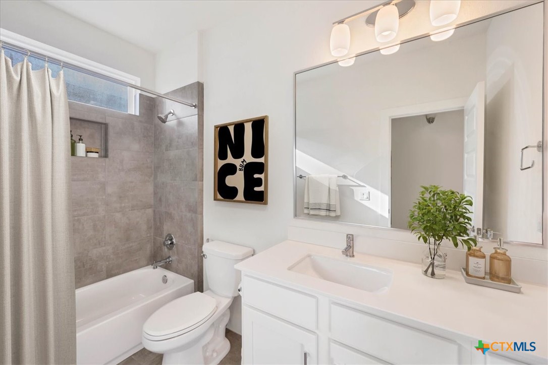 8922 Manchaca Road, Unit 906 Austin, TX 78748 - Photo 9 of 16 a bathroom with a sink a toilet a tub and shower