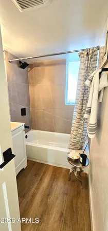 a bathroom with a bathtub a toilet and a shower