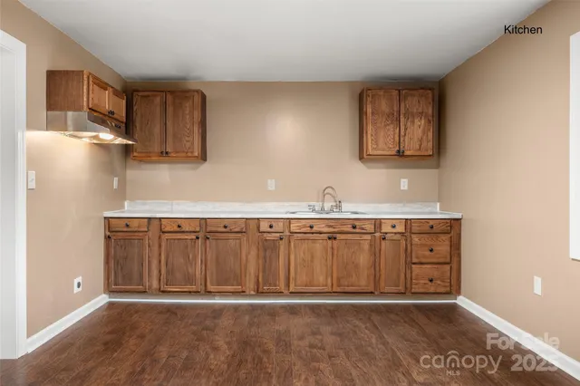 a view of a kitchen with a sink and a window