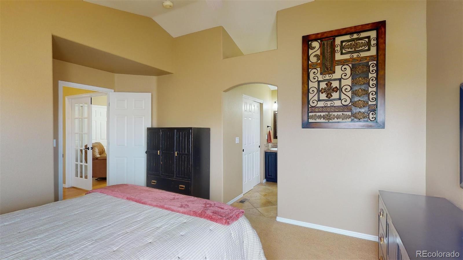 599 Timbervale Trail Highlands Ranch, CO 80129 - Photo 16 of 32 a bedroom with a bed and a table in it