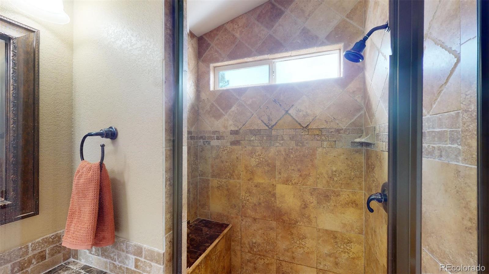 599 Timbervale Trail Highlands Ranch, CO 80129 - Photo 18 of 32 a bathroom with a shower