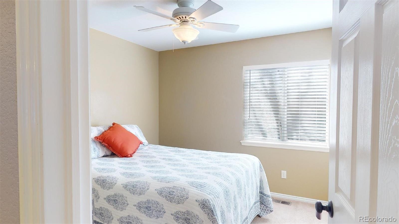 599 Timbervale Trail Highlands Ranch, CO 80129 - Photo 20 of 32 a bedroom with a bed and a window