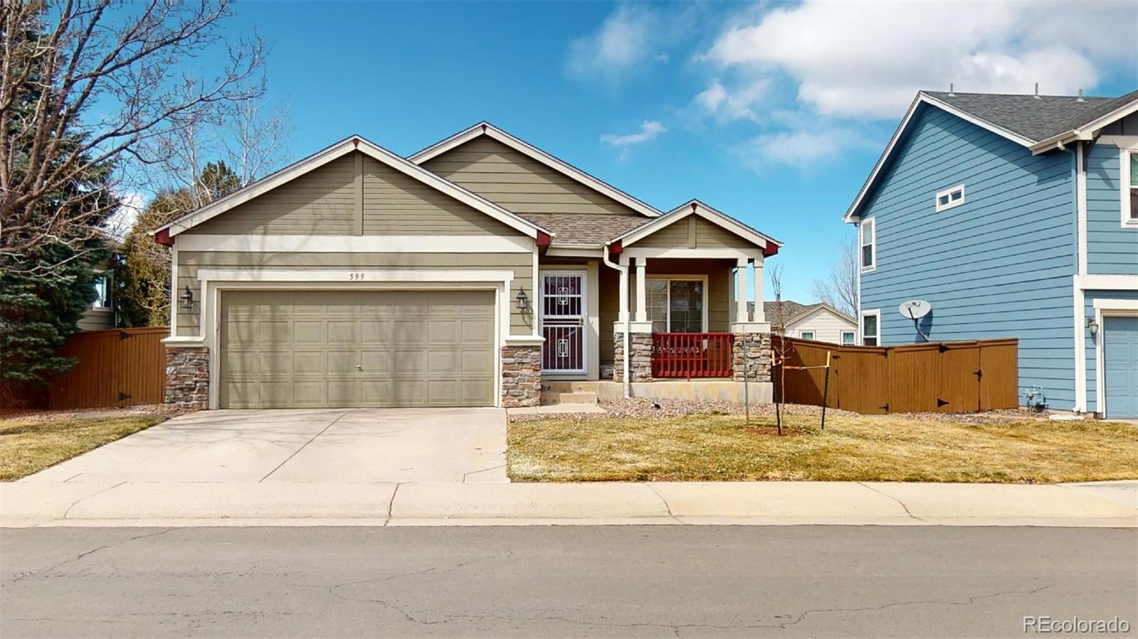 599 Timbervale Trail Highlands Ranch, CO 80129 - Photo 2 of 32 a front view of a house with a yard and garage