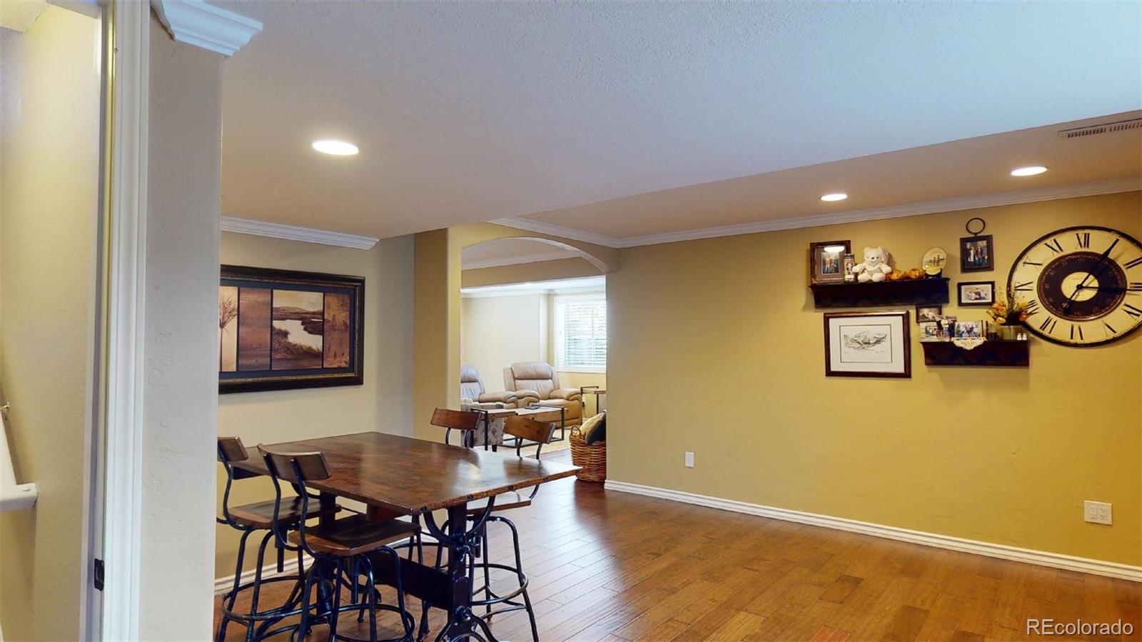 599 Timbervale Trail Highlands Ranch, CO 80129 - Photo 22 of 32 a view of a dining room with furniture and wooden floor